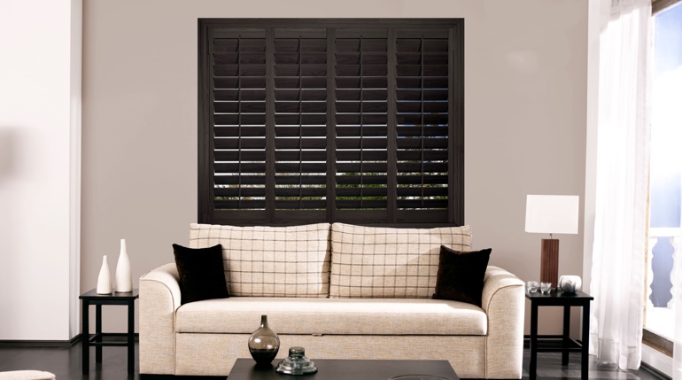 St. George sitting room with stained wood shutters.